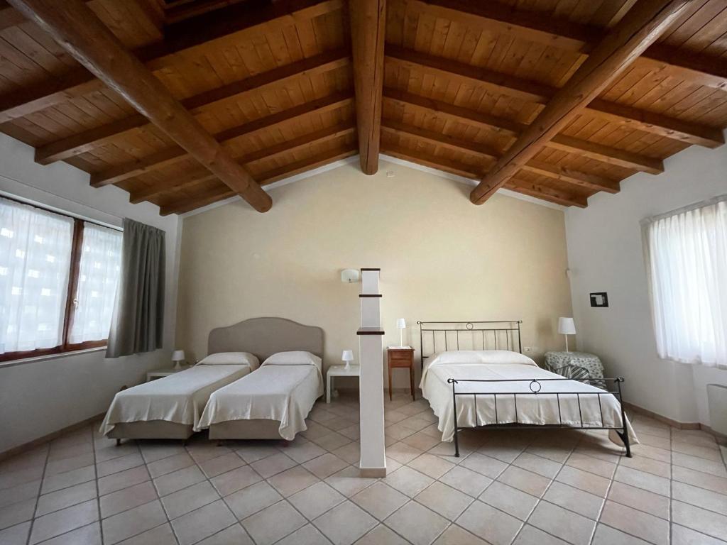 Postel nebo postele na pokoji v ubytování Agriturismo Bitturelli