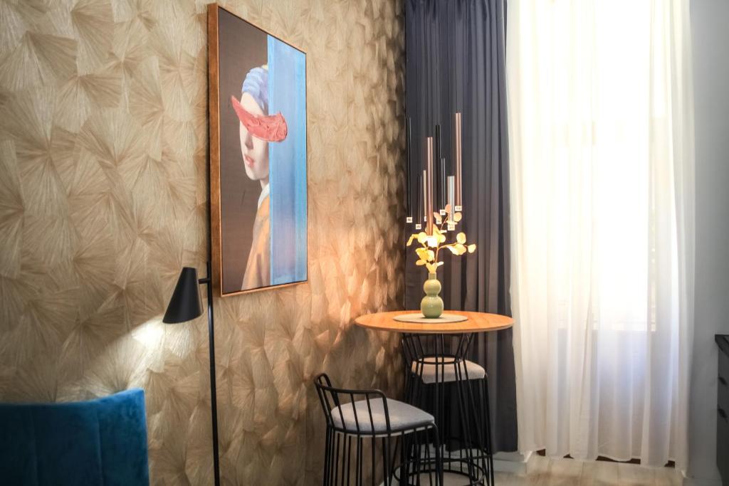 a dining room with a table and a picture on the wall at Hedone City Luxury Apartments with FREE PARKING in Pula