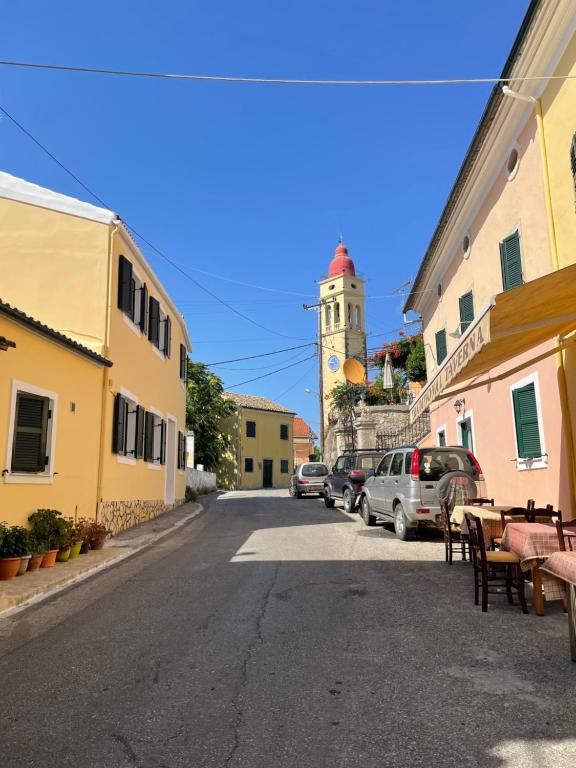 a street in a town with a clock tower at Anastasia’s Apartment in Sinarádes