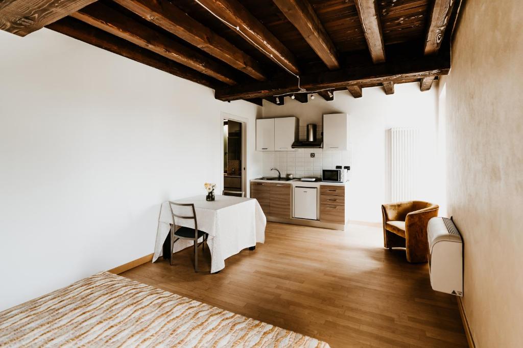 a living room with a white table and a kitchen at La Piu' Bella Verona in Verona