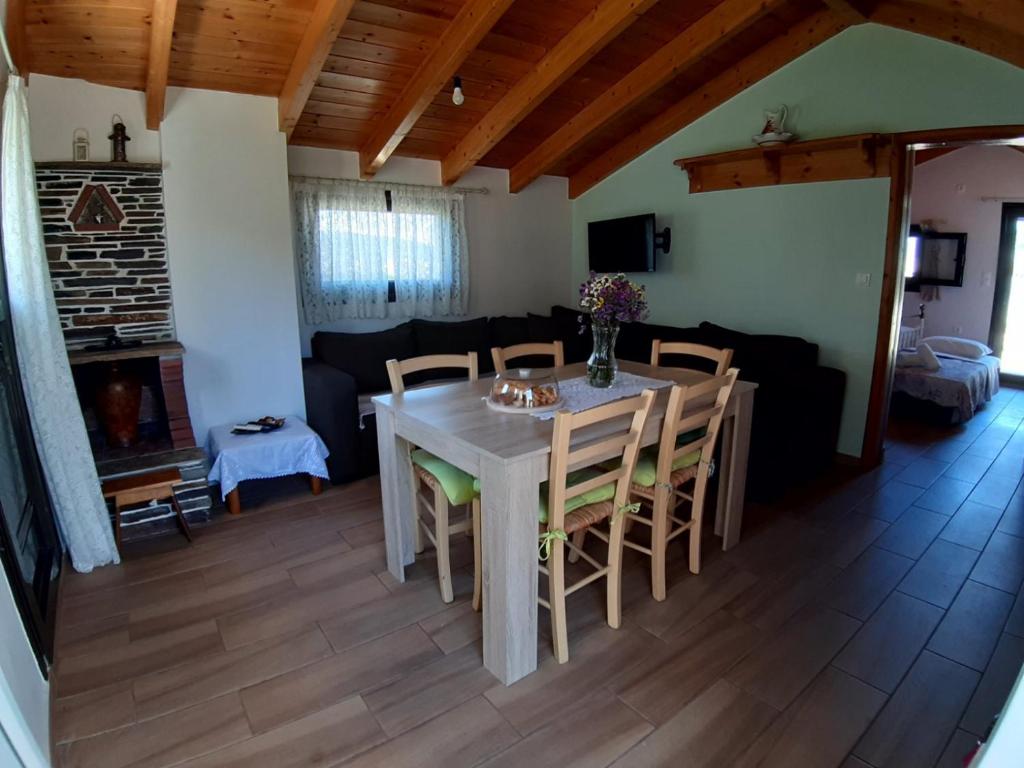 a dining room with a table and chairs and a couch at Traditional house in Akamatra square in Akamatra