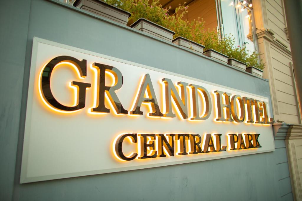 a sign for a grand hotel central park at Grand Hotel Baku Central Park in Baku