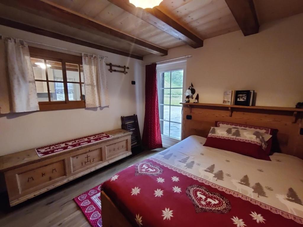 a bedroom with a large bed and a window at Fuchs Haus in Formazza