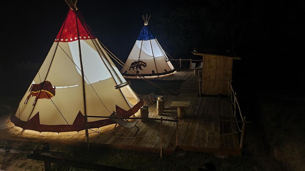 two boats with sails on a wooden deck at night at Tipi Bieszczady Puchary in Hoczew