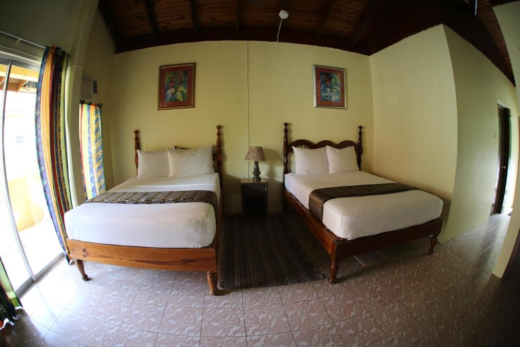 a bedroom with two beds in a room at Moonrisevillas in Negril
