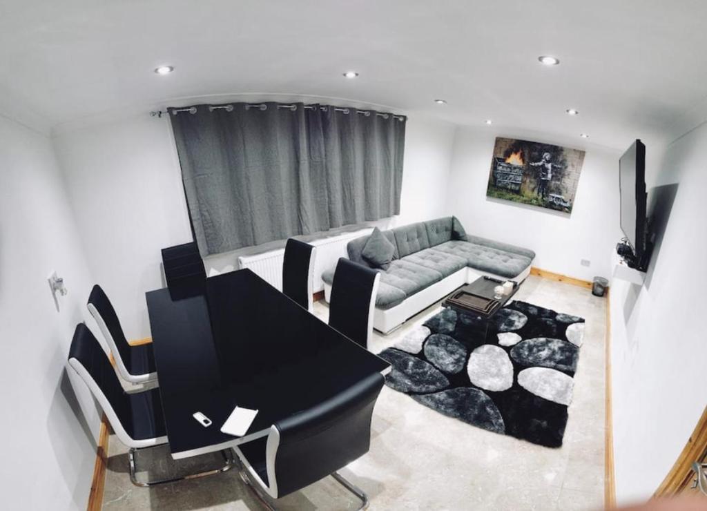 a living room with a couch and a table at Stratford city apartments in London