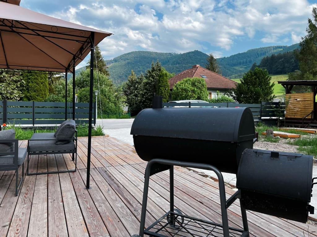 a bbq grill on a wooden deck at Wilson Paradise Guest House in Thenneberg