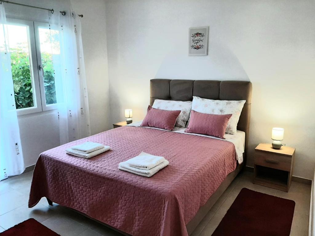 a bedroom with a large bed with two towels on it at Oaza in Komarna
