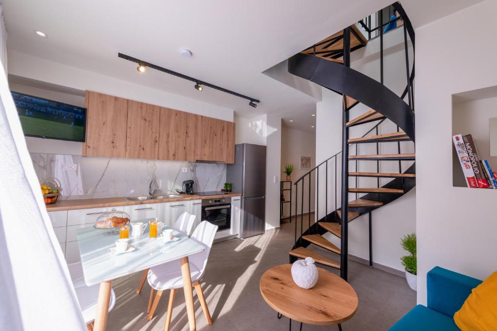 a kitchen and dining room with a staircase in a house at Deluxe Suites Irianna - in the heart of Old Town in Heraklio Town