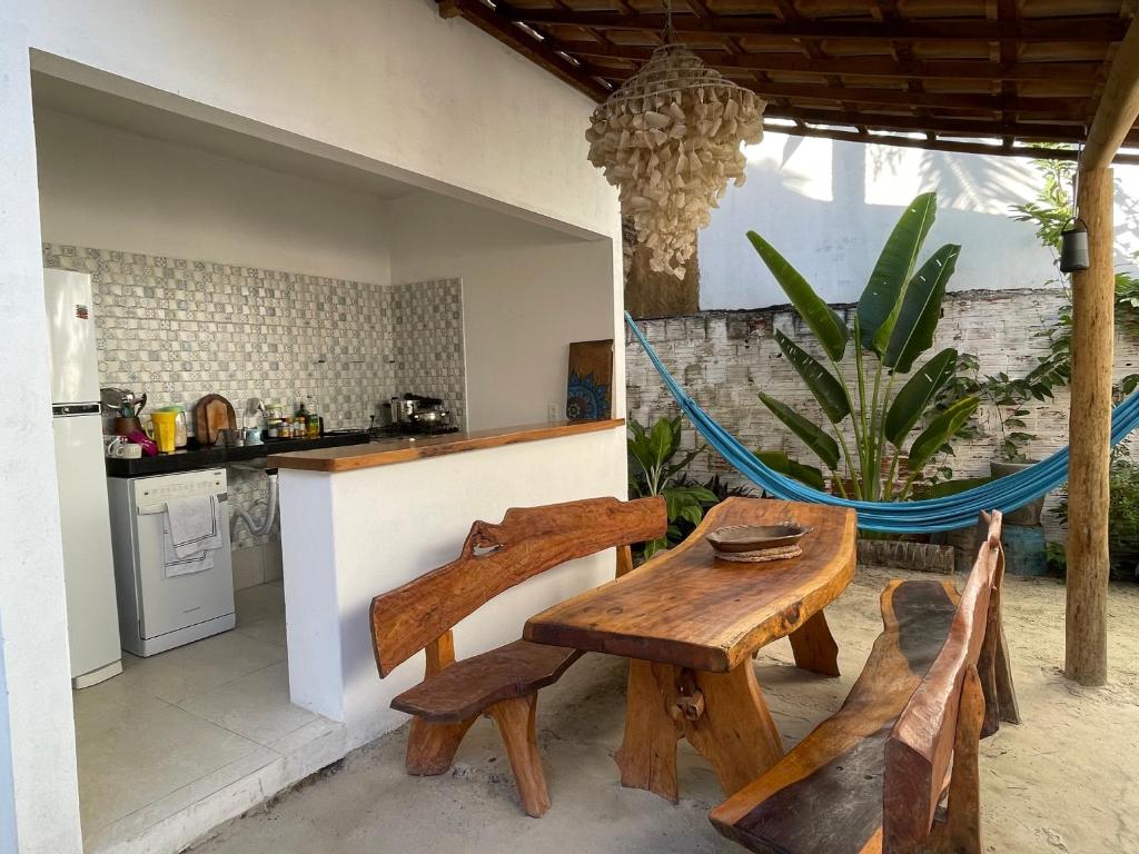 a kitchen with a table and chairs and a hammock at Villa Viana in Jericoacoara