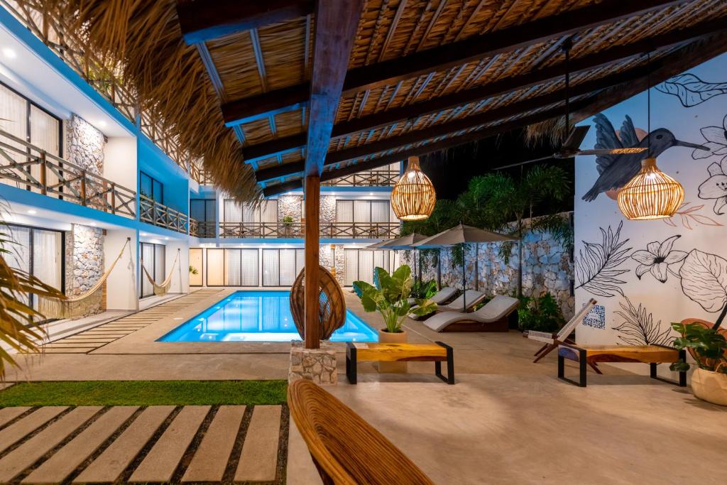 a villa with a swimming pool and a resort at Casa Bicachi - Adults Only in Puerto Escondido