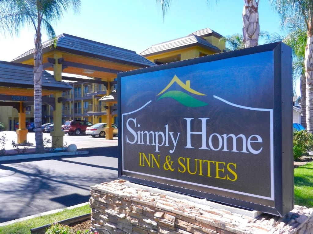 a sign for a small home inn and suites at Simply Home Inn & Suites - Riverside in Riverside
