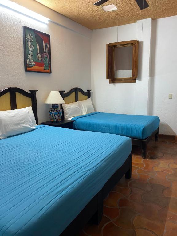 Postel nebo postele na pokoji v ubytování Hotel del Sol