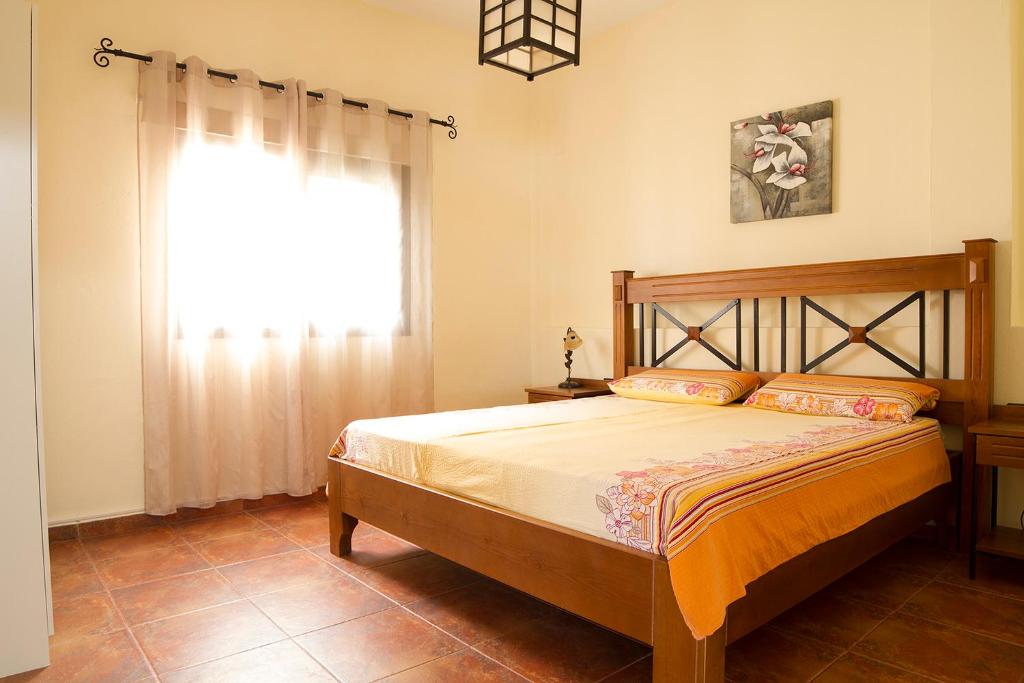 a bedroom with a large bed with a window at Tenerife Healing Garden in Guía de Isora