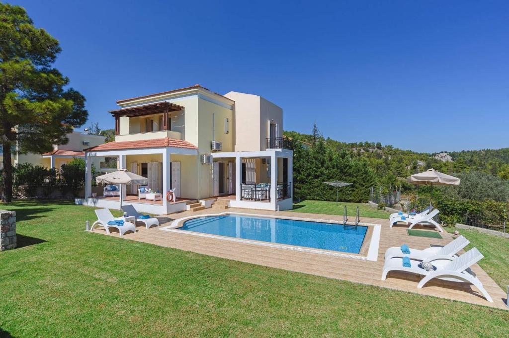 une villa avec une piscine et une maison dans l'établissement Villa Ermis Springs by Villa Plus, à Kolimbia