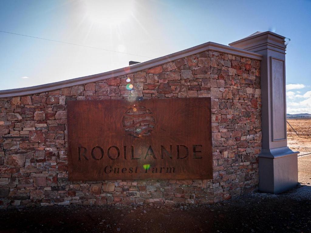 a sign for the rockland cross party on a brick building at Rooilande Guest Farm Guest House in Laingsburg