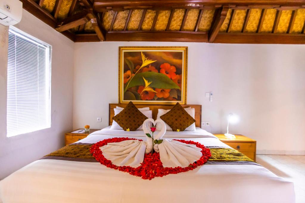 Postel nebo postele na pokoji v ubytování Seken Cottages Ubud