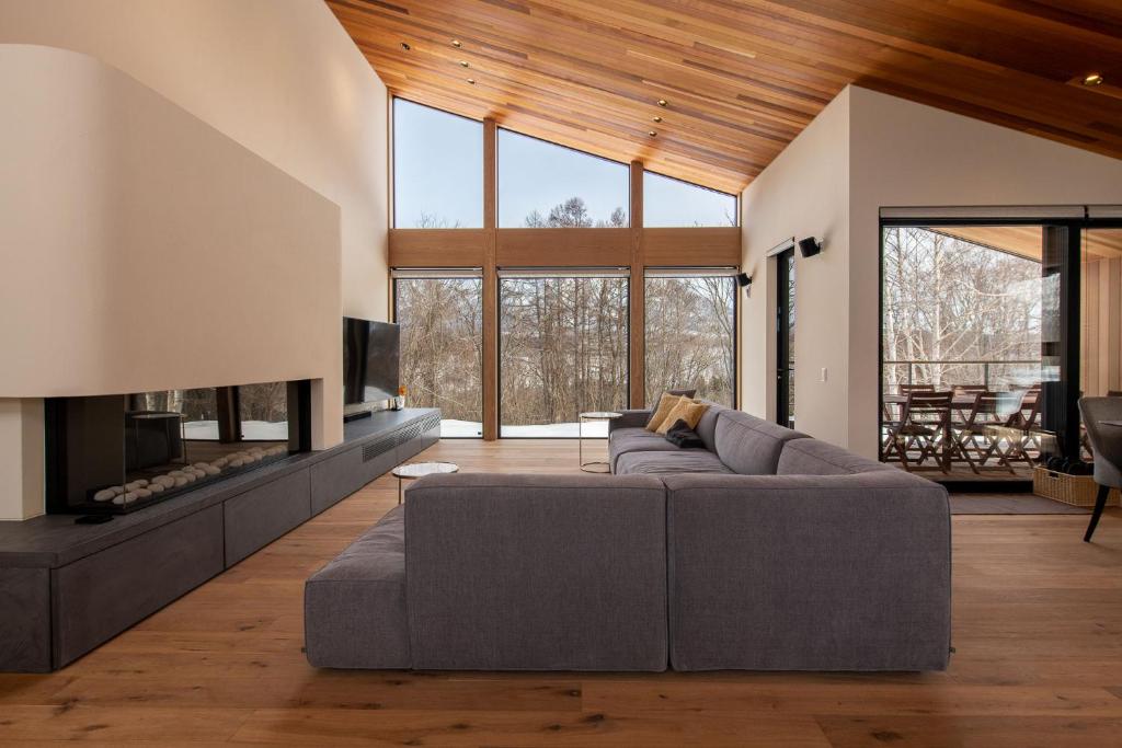 a living room with a couch and a fireplace at Shion - 森音 in Kutchan