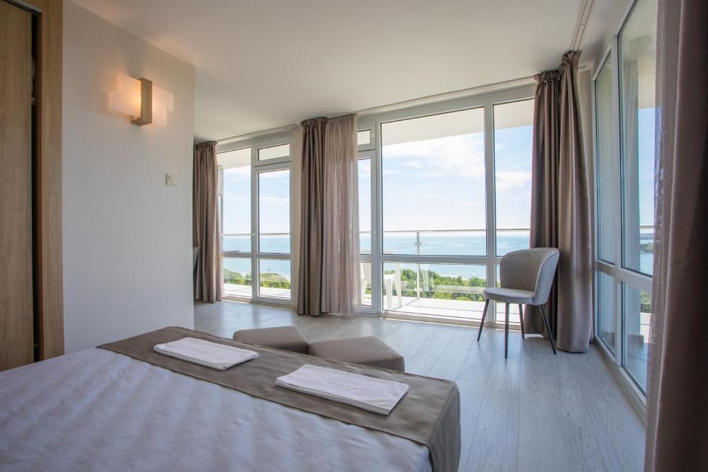 a bedroom with a bed and a large window at Hotel Coop - Kiten in Kiten