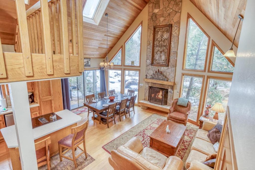 a living room and dining room with a fireplace at Yankee Mountain 9 - Meredith Lodging in Sunriver