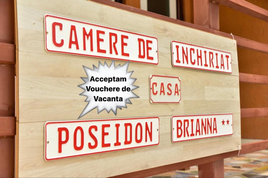 a wooden box with street signs on it at Casa Poseidon in Costinesti