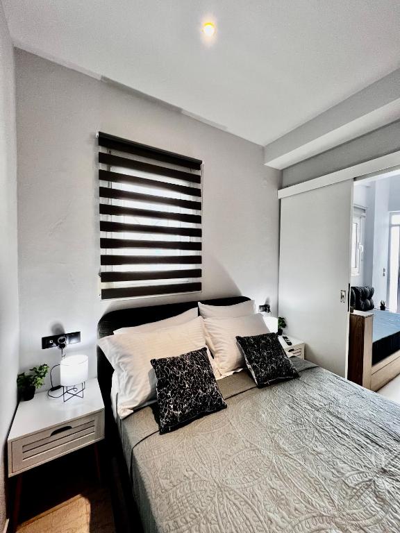 a bedroom with a bed with two pillows on it at Central Double Room Ground floor in Heraklio