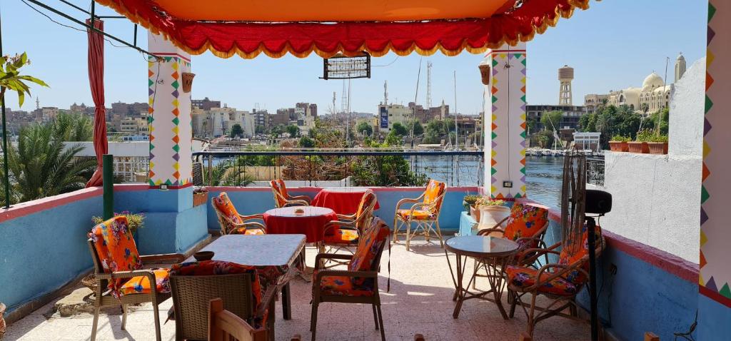 a patio area with a table, chairs and umbrellas at Nuba Dool Guest House in Aswan