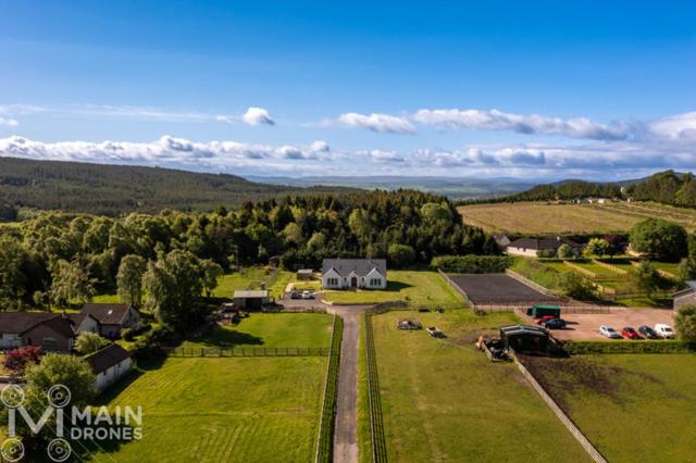 an aerial view of a farm with a house at Drumlochy B&B in Inverness