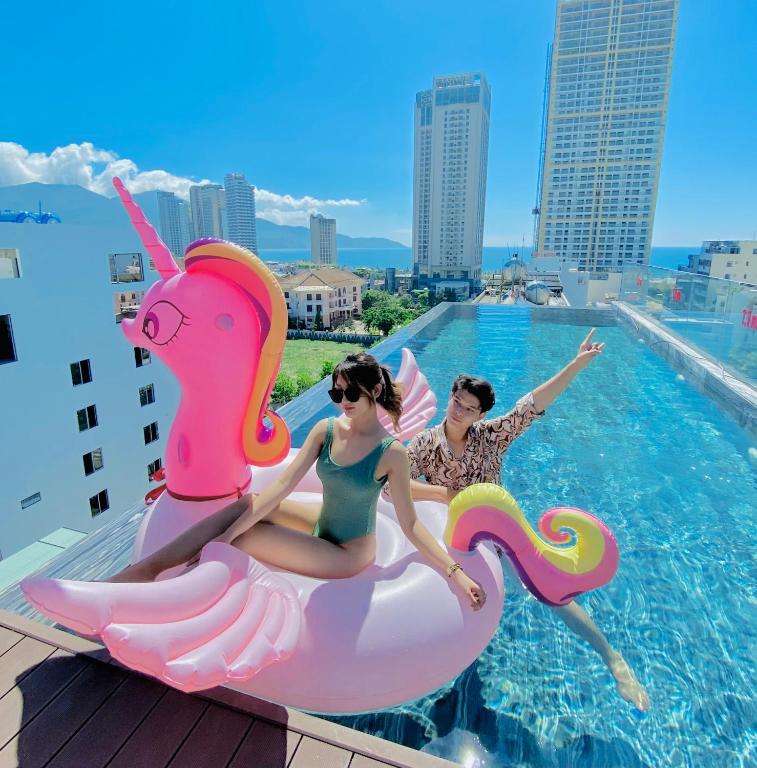 two people riding on an inflatablevisorvisorvisorvisorvisor at Duke Casa Apartment in Danang