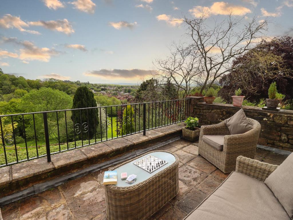 a patio with chairs and a table on a balcony at The Grooms in Lydney