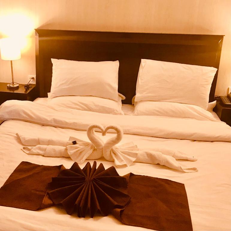 a bed with two towels and a heart on it at Boutiqueinn Ayubia in Ayubia