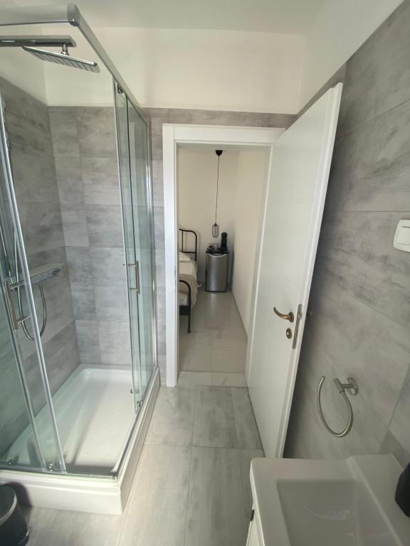 a bathroom with a walk in shower and a sink at Litore in Pula