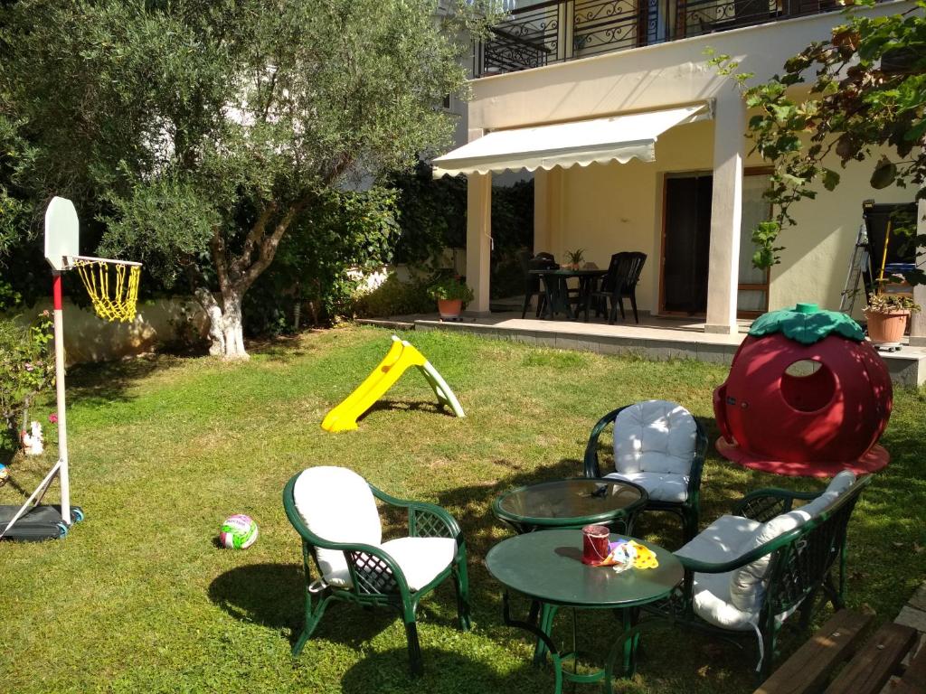 a backyard with a table and chairs and a basketball hoop at Apartment Villa Panorama in Thessaloniki