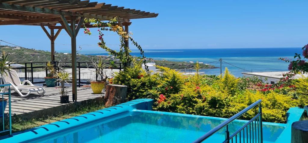 a villa with a swimming pool and a view of the ocean at Villa Paradise Rodrigues in Rodrigues Island