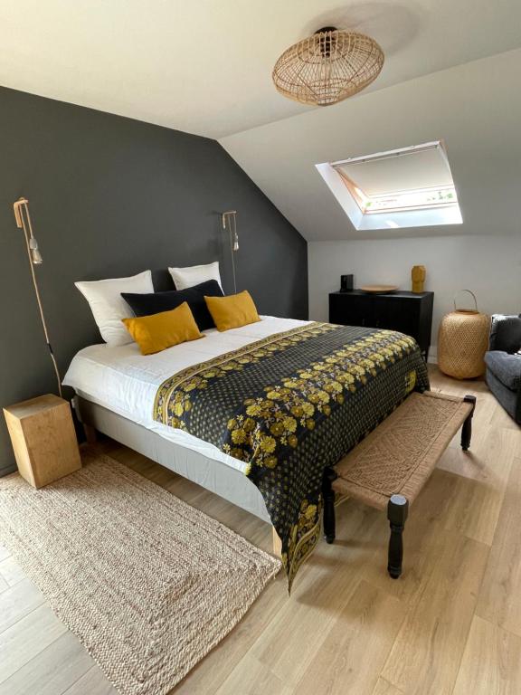 ein Schlafzimmer mit einem großen Bett mit gelben Kissen in der Unterkunft La Poterie - Chambres d'hôtes / Bed & Breakfast in Ath