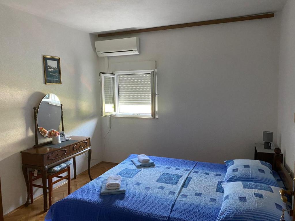 Postel nebo postele na pokoji v ubytování Apartmani Udovicic