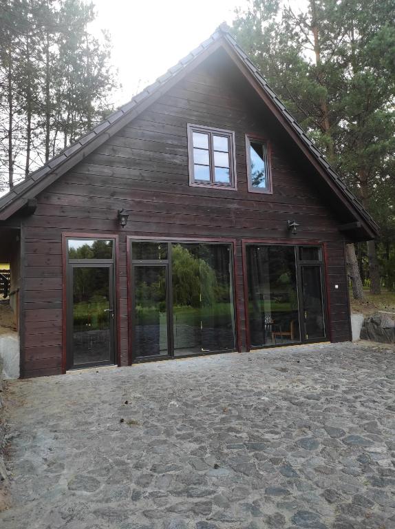 a house with large windows on the side of it at Dom Wakacyjny Krawno in Piecki