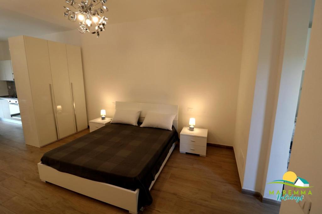 A bed or beds in a room at M.H Bovio Apartment