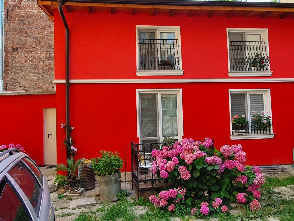 czerwony dom z kwiatami przed nim w obiekcie Modern and Old LODGE w mieście Sofia