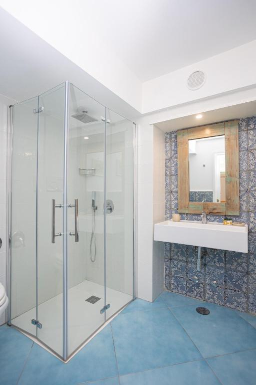 a bathroom with a glass shower and a sink at La Bella Annacapri in Anacapri