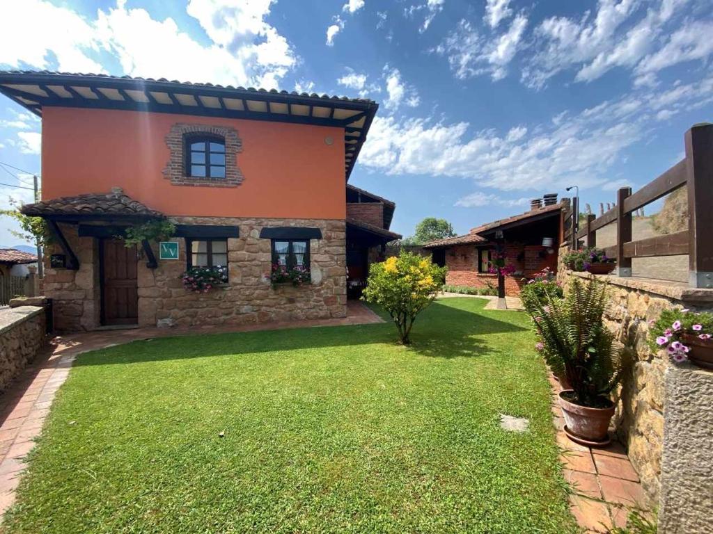 a house with a green lawn in front of it at Vivienda Vacacional La Vara VV-1433-AS in Arriondas