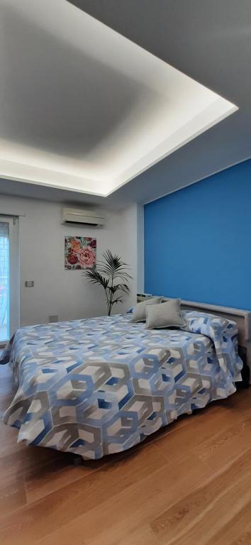 ein Schlafzimmer mit einem großen Bett mit blauer Wand in der Unterkunft CASA VACANZE LE PALME in Gaeta