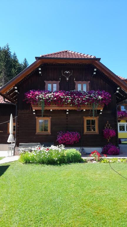 a house with flowers on the side of it at Chalet Taurachblick in Tamsweg