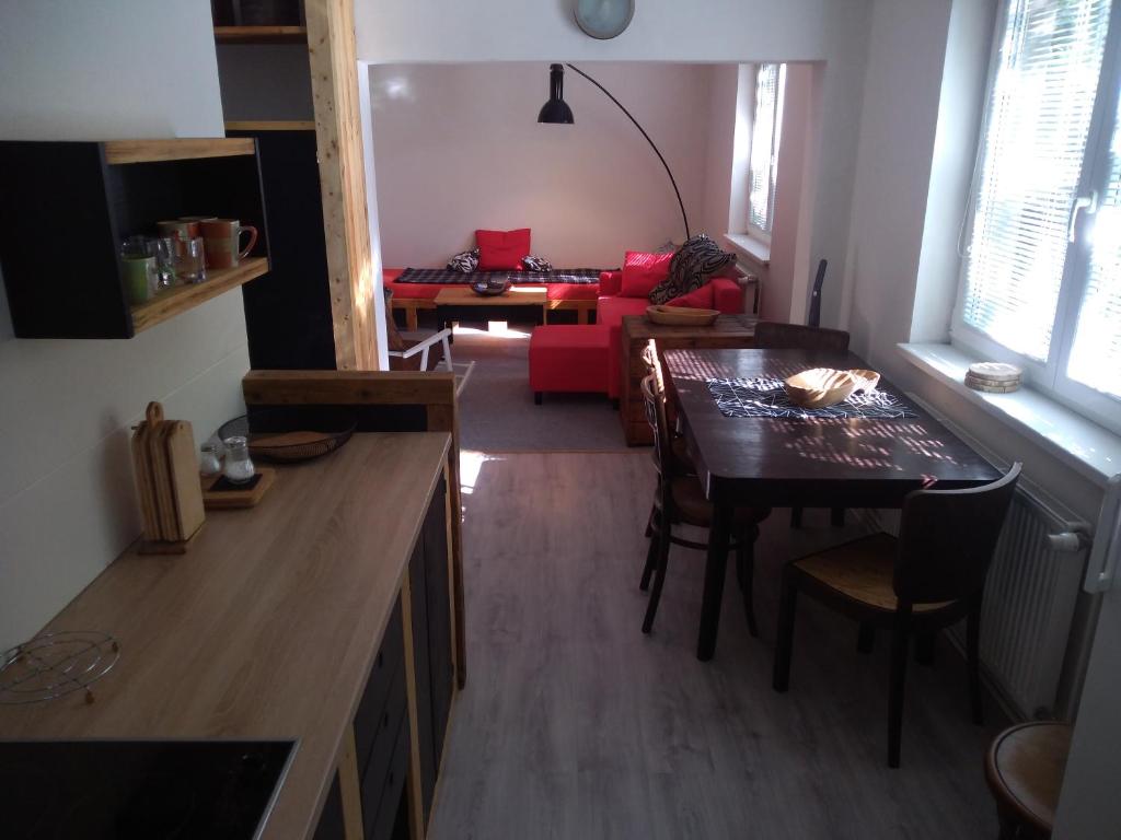 a kitchen and living room with a table and a dining room at Apartman HF in Liberec