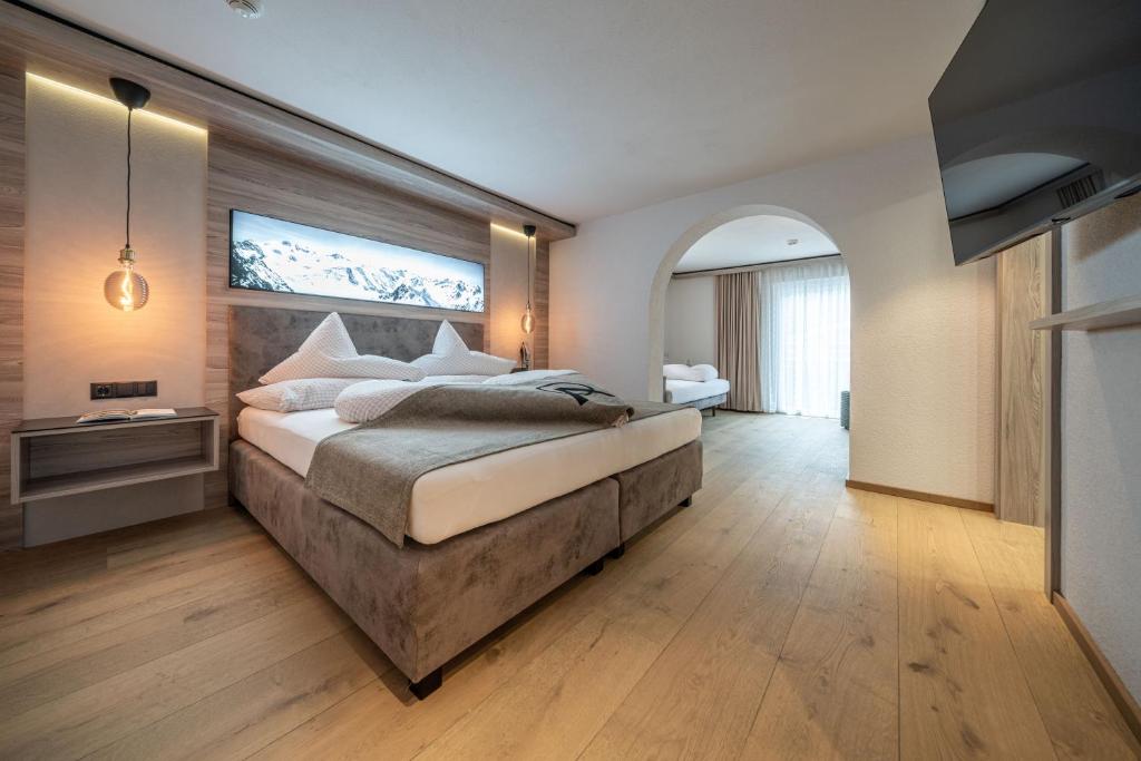 Postel nebo postele na pokoji v ubytování Genusshotel Alpenblick