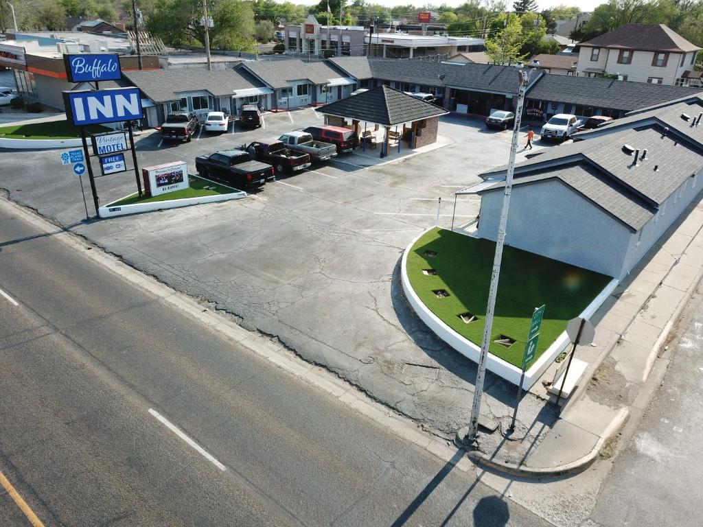 a boat parked in a parking lot next to a street at Buffalo Inn Vintage MOTEL in Canyon