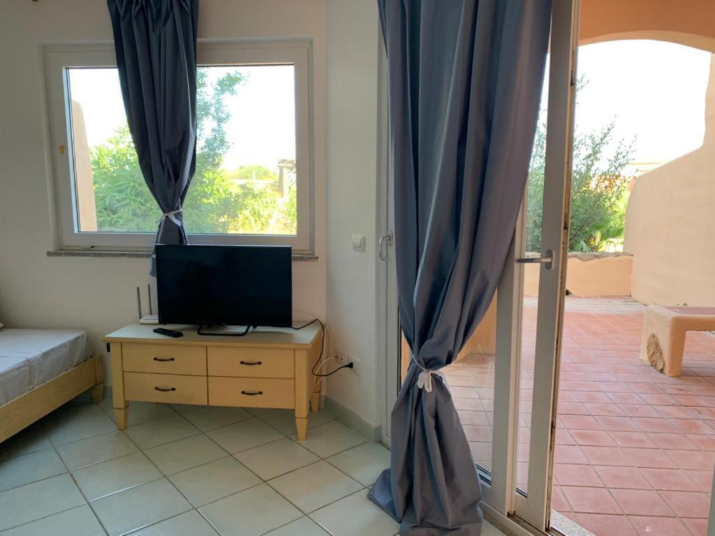 TV a/nebo společenská místnost v ubytování Residence Cala Rossa