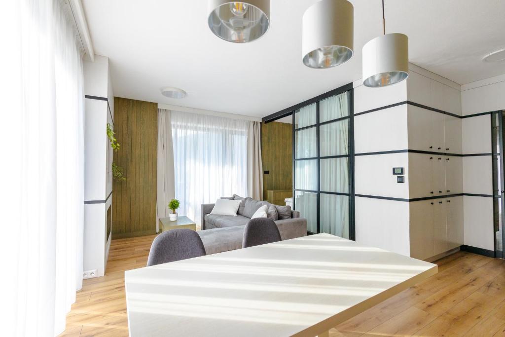 a living room with a table and a couch at HILLHOME apartment & Sauna in Donovaly