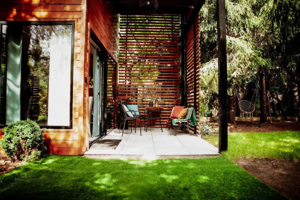 a patio with chairs and a brick house at Domek w Długosiodle in Długosiodło