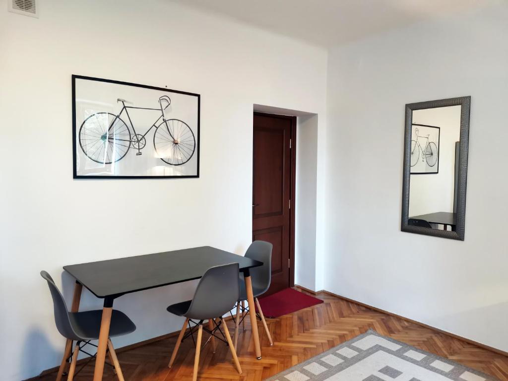 a dining room with a table and chairs and a bike on the wall at Ohotelik Pensjonat w Poniatowej in Poniatowa